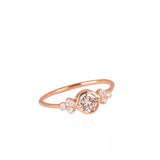 ring with white small diamonds framing a bigger recycled light brown diamond