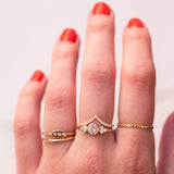 hand wearing 18k gold rings with diamonds