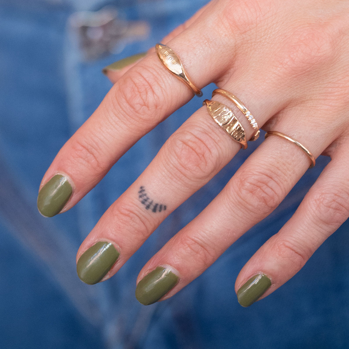hand with 18k gold rings