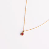 18k gold necklace with a round ruby
