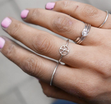Silver stacking rings together with a 18k white gold diamond ring