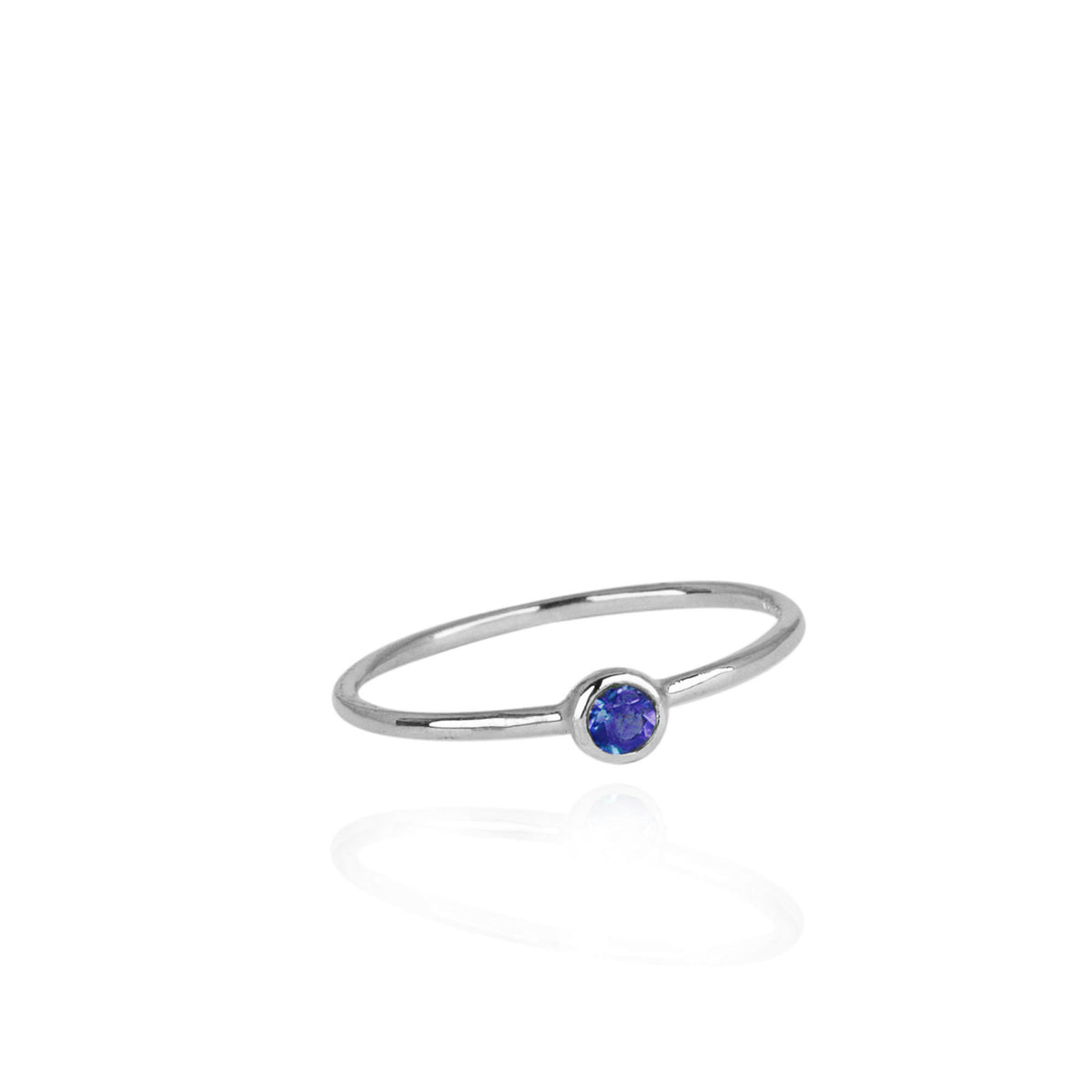 silver ring with tiny round blue sapphire