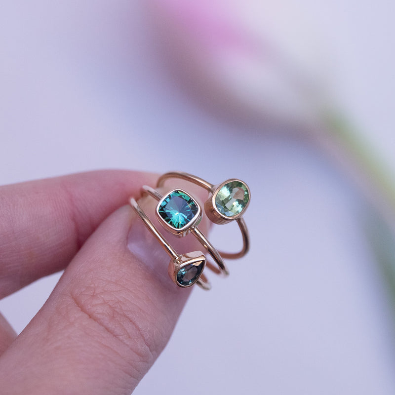 gold rings with green stones