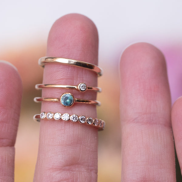 gold rings with gemstones on a finger