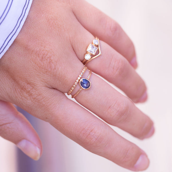 model hand wearing caroline hjerpe gold rings