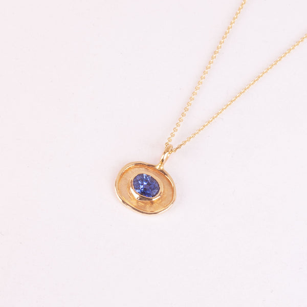 gold amulette neckalce with blue sapphire