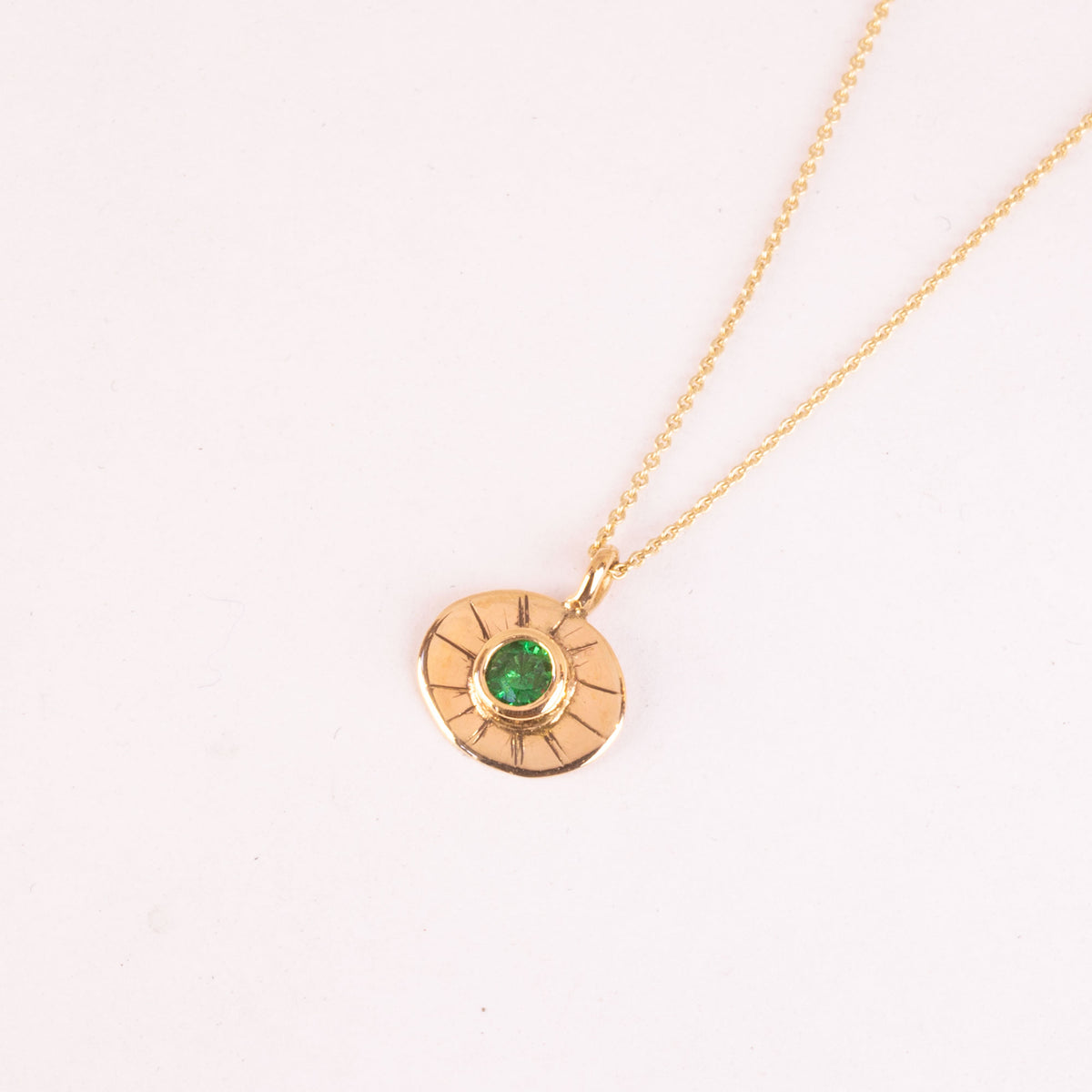 18k gold necklace with green gemstone amulette