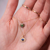 hand holding gold necklaces