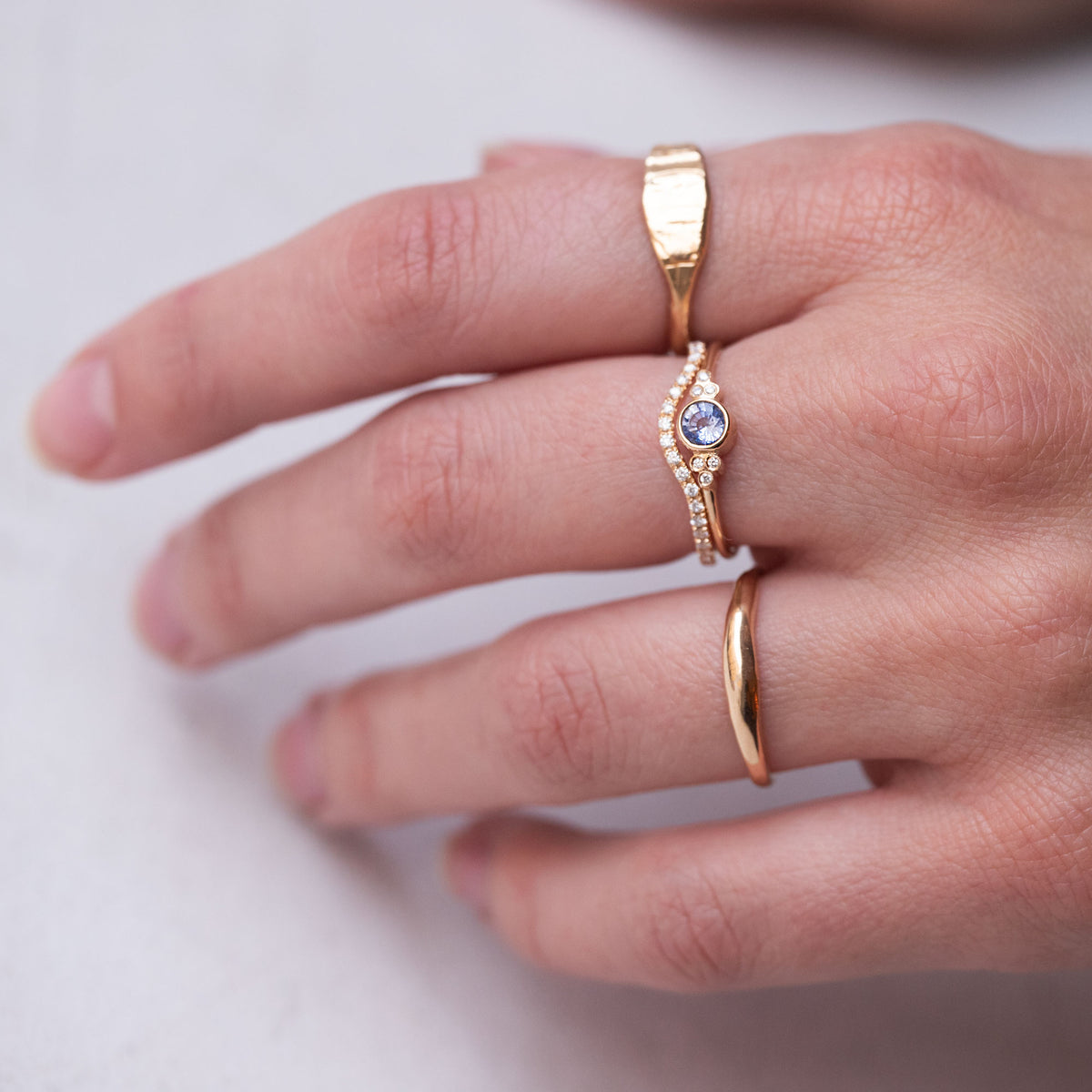 hand wearing handmade gold rings