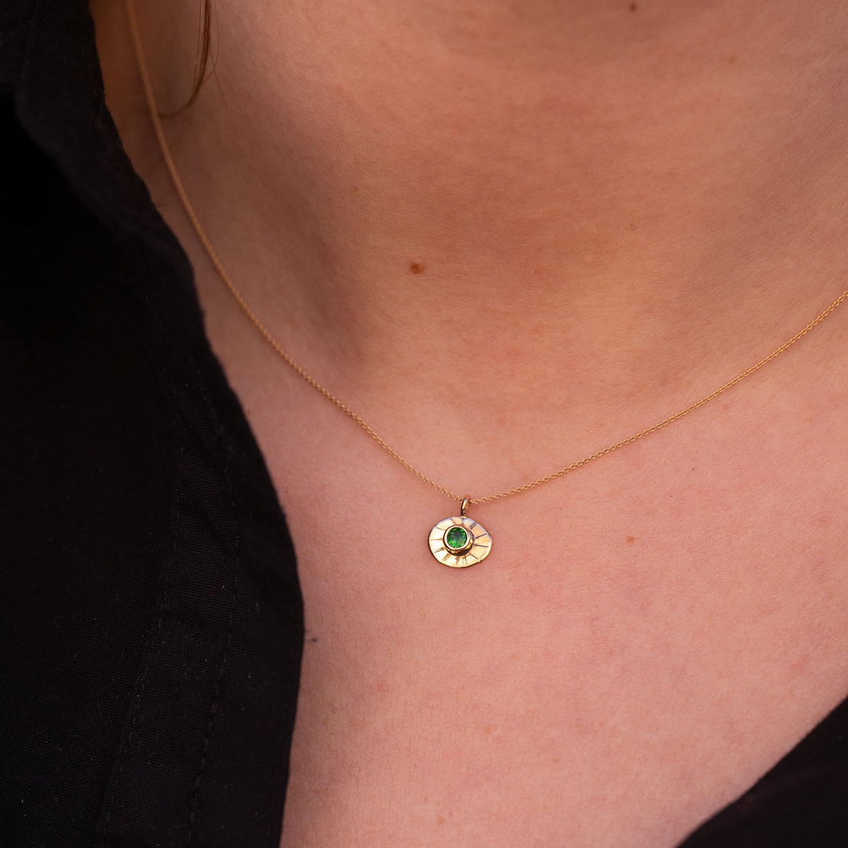 gold neckalce with green gemstoe