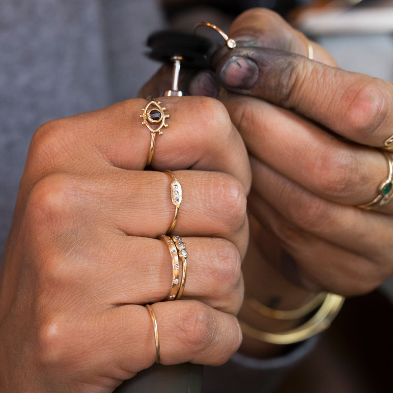 goldsmith working on gold diamond ring