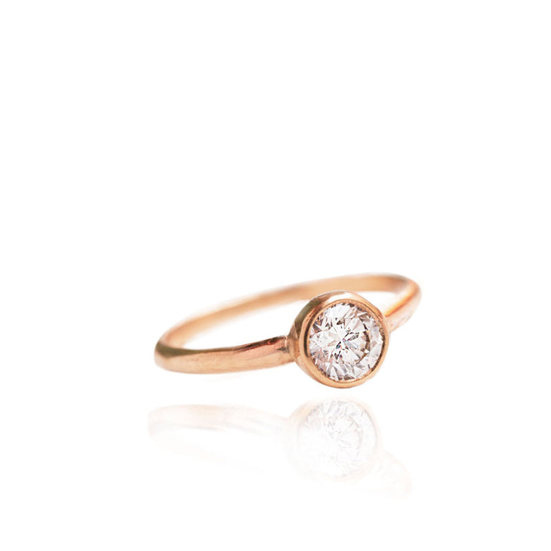 Handmade engagement ring with a brilliant cut 0.7ct diamond, hand set in a classic bezel setting