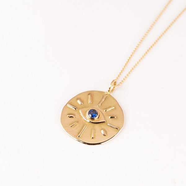 gold necklace with evil eye